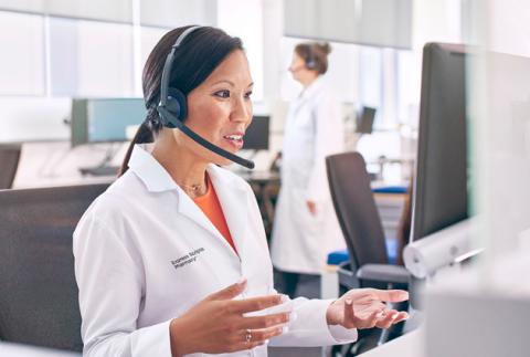 Young, asian female pharmacist wearing a headset answering questions about ESC online pharmacy's 24/7 delivery service