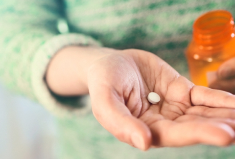 A pill on someone's hand